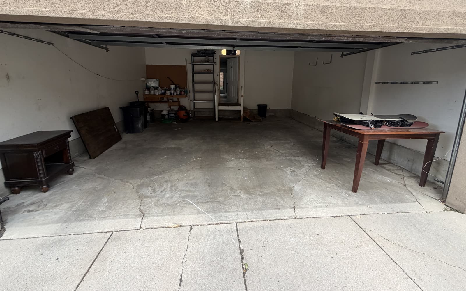 The same two-car garage emptied down to bare concrete, ready to park in.